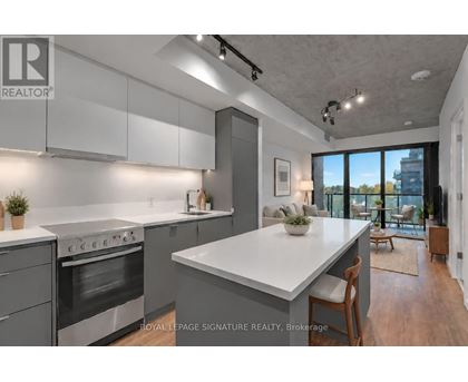 A modern kitchen with a large island and stainless steel appliances.