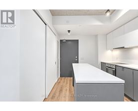 A white kitchen with a large island in the middle.