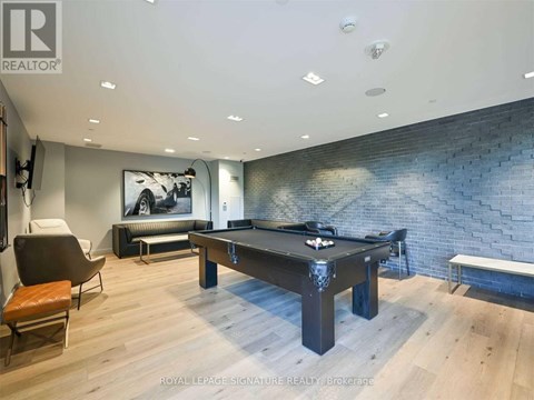 A room with a pool table and a bench.