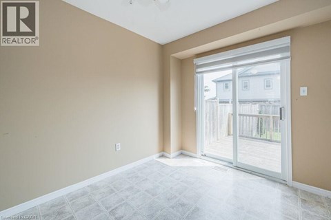 A room with a sliding glass door leading to a balcony.