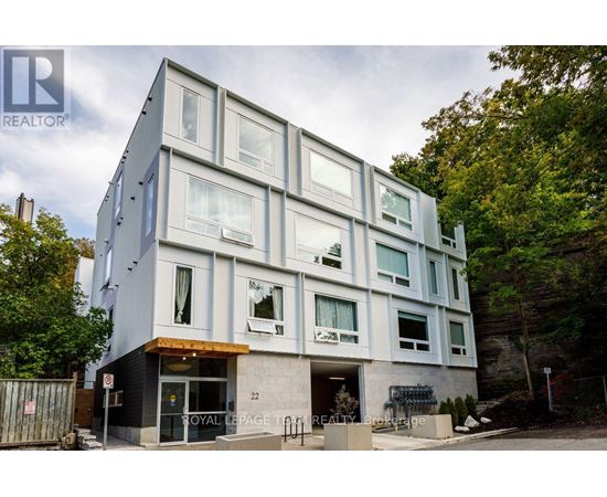 A modern building with a glass facade and a sign that reads "Royal LePage RE/MAX".