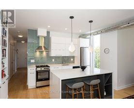 A modern kitchen with white cabinets and a large island.