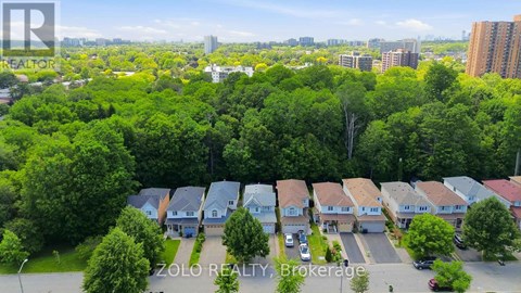 A bird's eye view of a residential area with houses and trees.