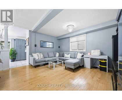 A living room with a grey couch and a coffee table.