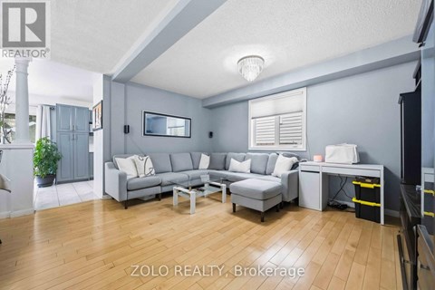 A living room with a grey couch and a coffee table.