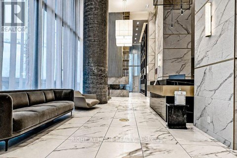 A marble hallway with a bench and a reception desk.
