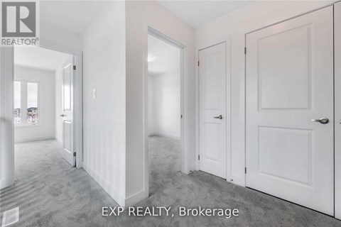 A white hallway with EXP REALTY, Brokerage written on the floor.