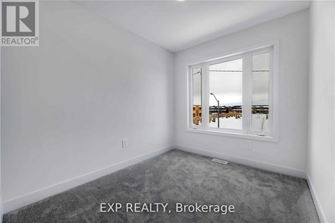 A room with a large window and a view of a street.