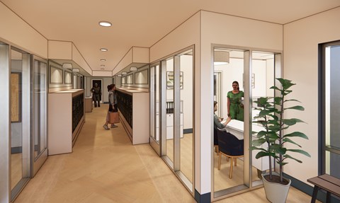 A long hallway with people walking and sitting.