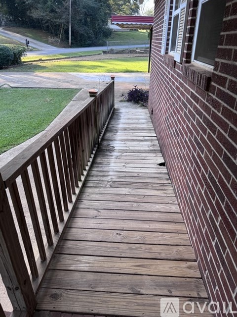 A wooden deck leads to a grassy area.