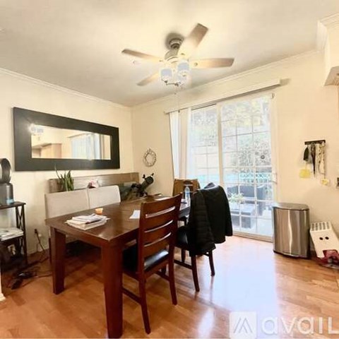 A dining room with a wooden table and chairs.