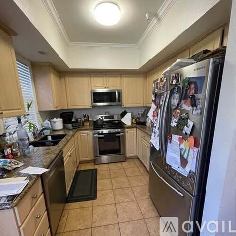 A kitchen with wooden cabinets and a fridge with magnets on it.