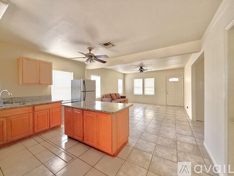 A kitchen with orange cabinets and a white refrigerator.