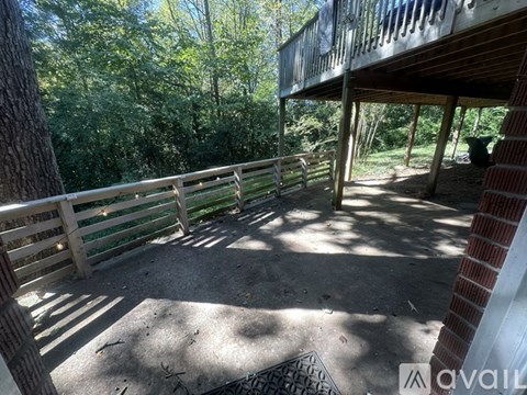A balcony with a railing and a view of trees.
