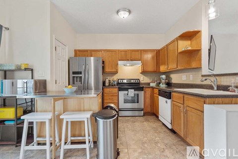 A kitchen with wooden cabinets and white appliances.