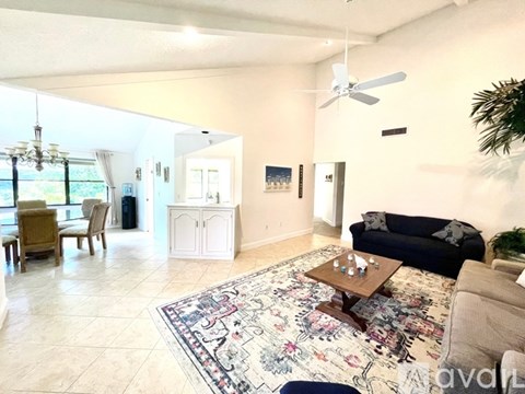 A living room with a rug on the floor and a couch.
