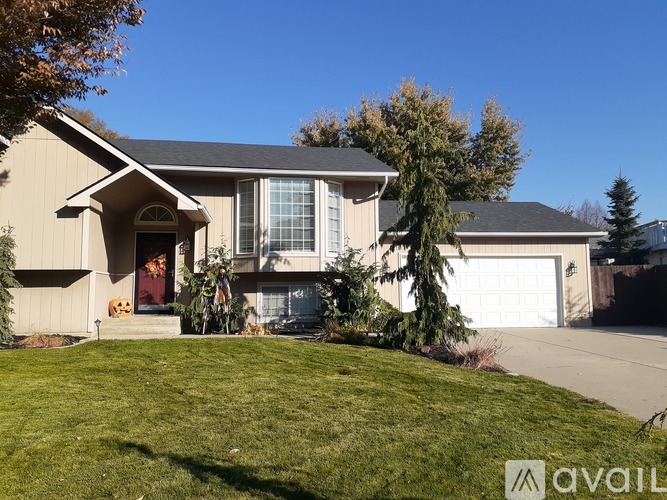 A house with a brown roof and a white garage door.