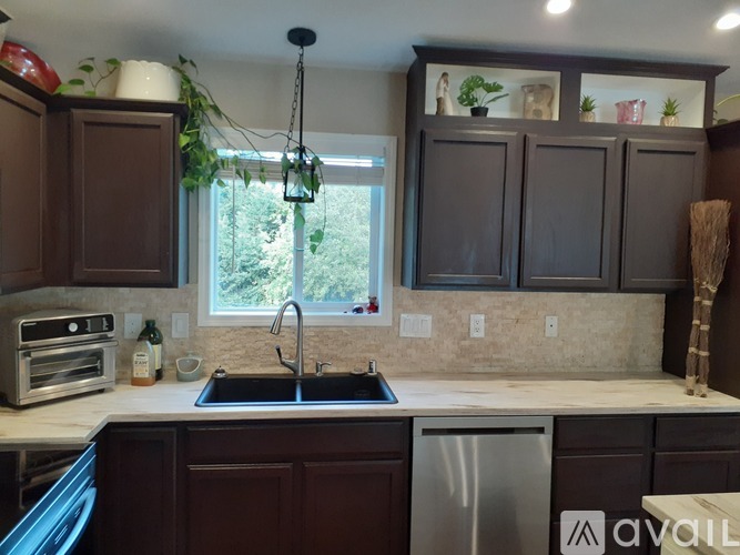 A kitchen with brown cabinets and a stainless steel dishwasher.