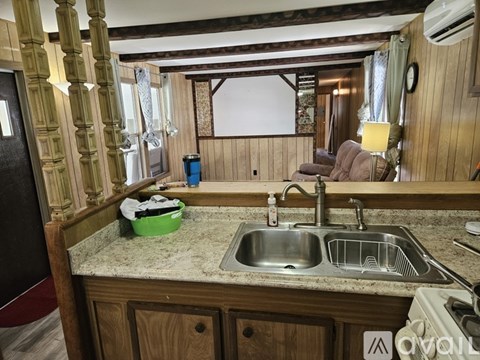 A kitchen with a sink and a counter.