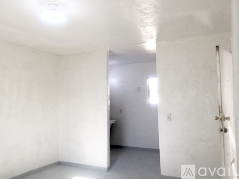 A white room with a door and a window.