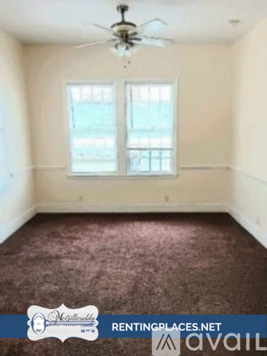 A room with a ceiling fan and a window.