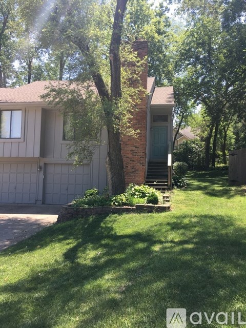 A house with a tree in front of it.