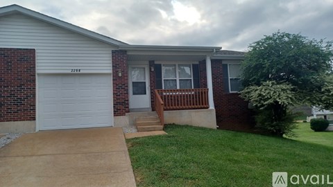 A house with a garage and a driveway in front.