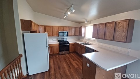 A kitchen with wooden cabinets and a white refrigerator.