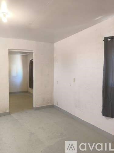 A room with a doorway leading to another room.