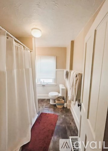 A bathroom with a toilet, sink, and shower.