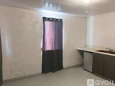 A room with a black curtain and a white wall.