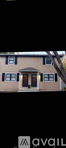 A house with a brown roof and a white door.