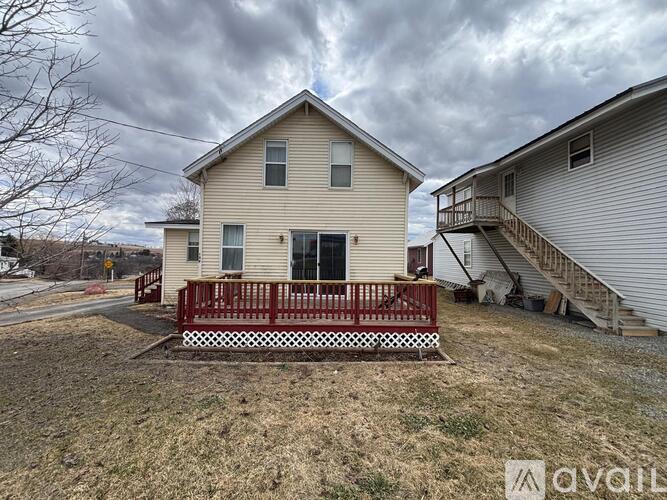 A house with a red fence is for sale.