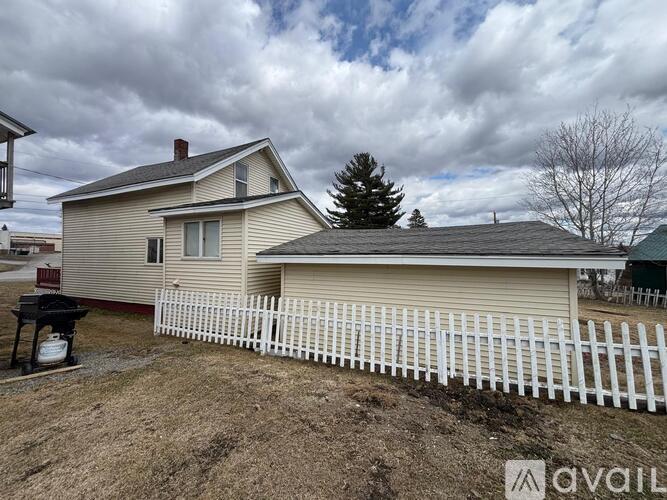 A house with a white picket fence in front of it.