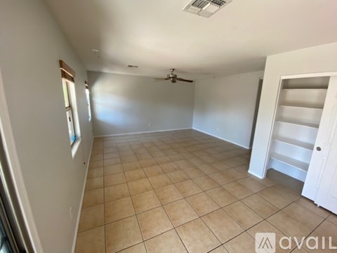 A room with a tiled floor and a ceiling fan.