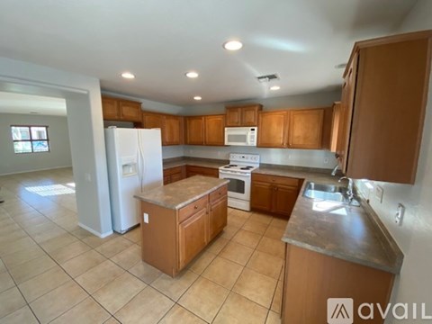 A kitchen with wooden cabinets and a white refrigerator.