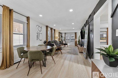 A modern dining room with a wooden table and chairs.