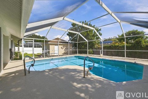 A pool under a white canopy with a ladder on the side.