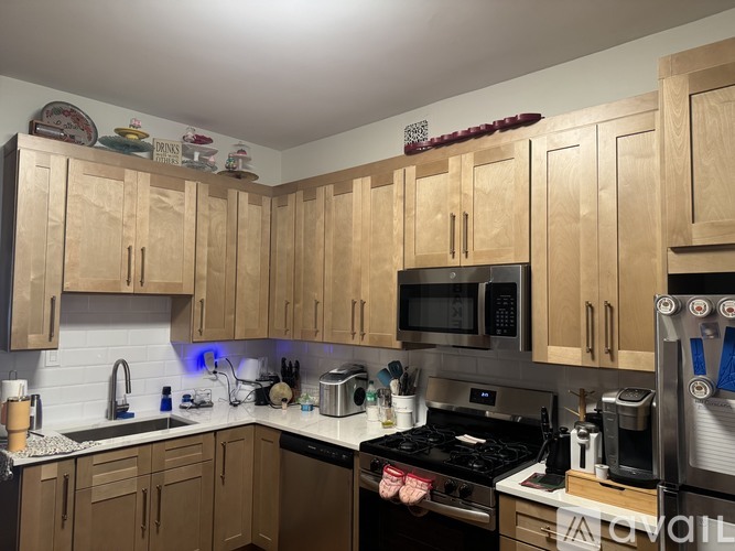 A kitchen with wooden cabinets and a black stove top.