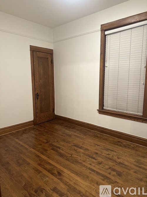 A room with a wooden floor and a wooden door.
