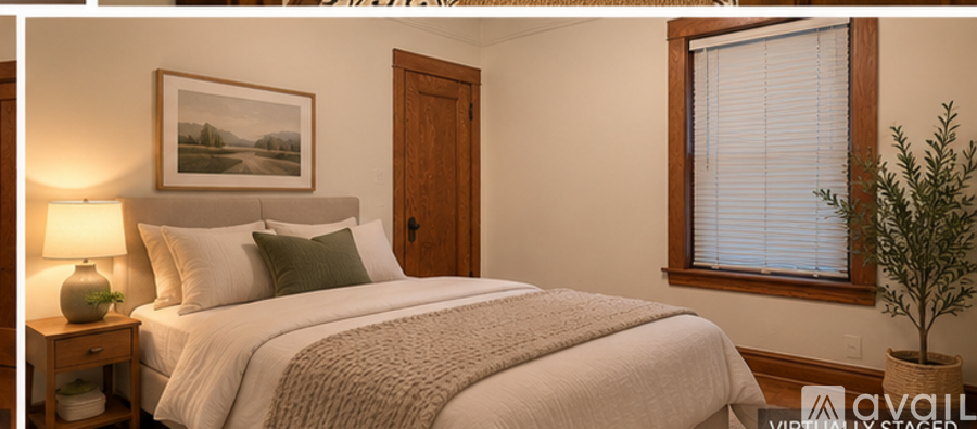 A bedroom with a large bed and a painting on the wall.