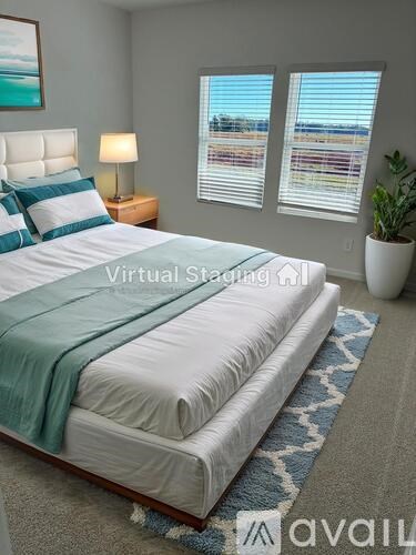 A bedroom with a large bed and a view of the city through the window.