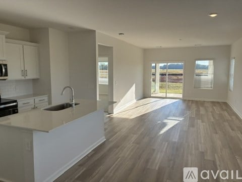 A spacious kitchen with wooden floors and a large island.