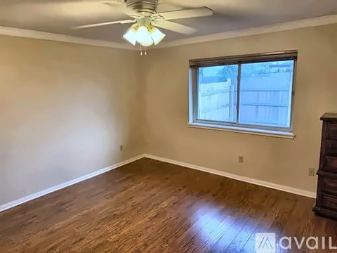 A room with a ceiling fan and a window.