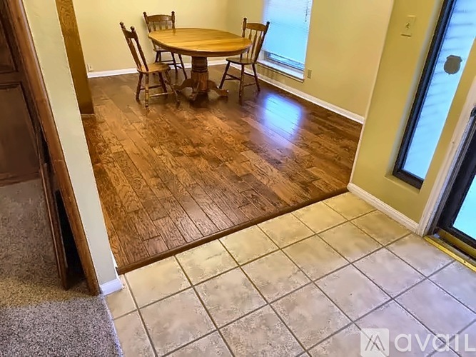 A dining room with a wooden table and chairs.