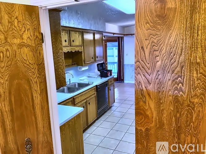 A kitchen with wooden cabinets and a countertop.