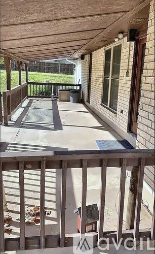 A patio with a deck and a railing.