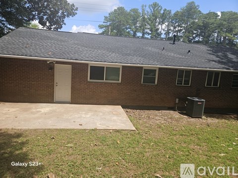 A house with a brown brick exterior and a white door.