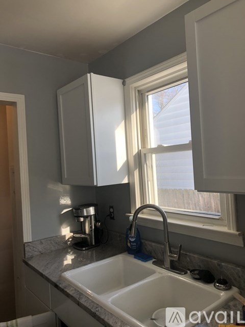 A kitchen with a sink and a window.