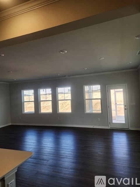 A room with a wooden floor and a large window.